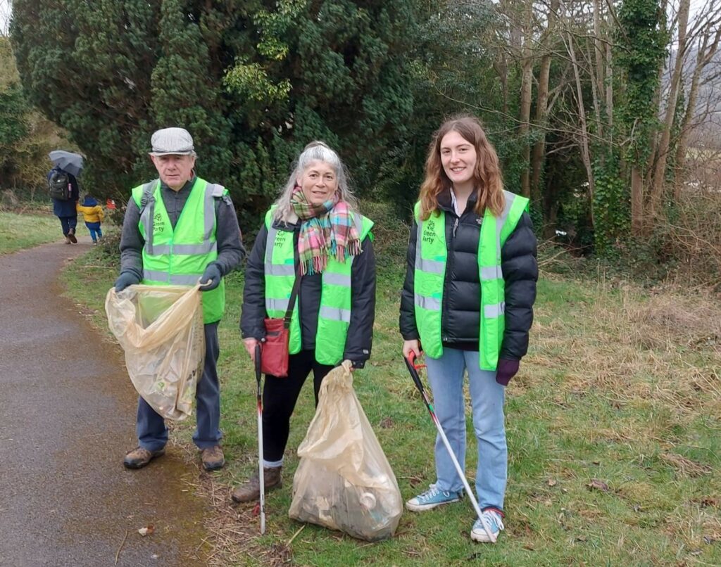 Lucas, Sue and Pippa in the cemetery with bags of rubbish